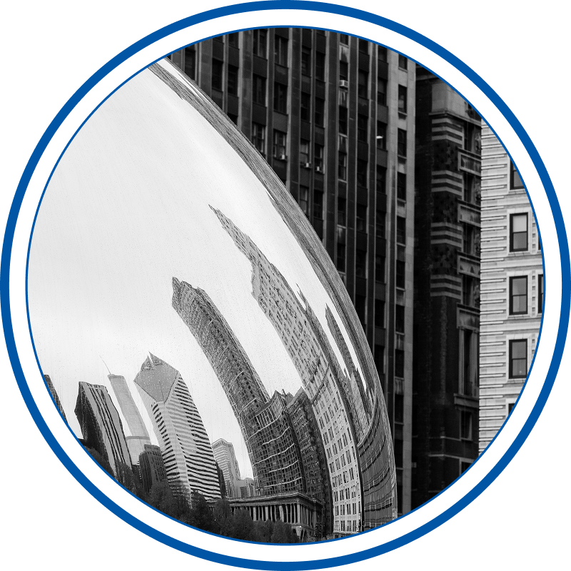 Reflection of tall city buildings on the metallic, curved surface of the bean in Chicago, IL.