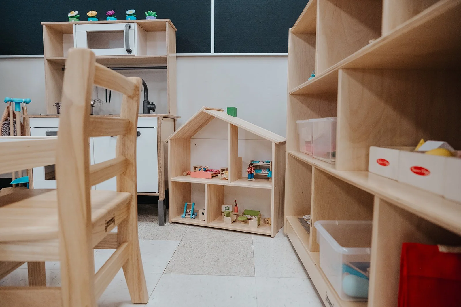 Wooden toys and shelves in a classroom or playroom.