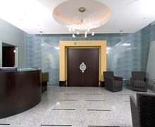 Hotel lobby with elevator, seating area, and chandelier