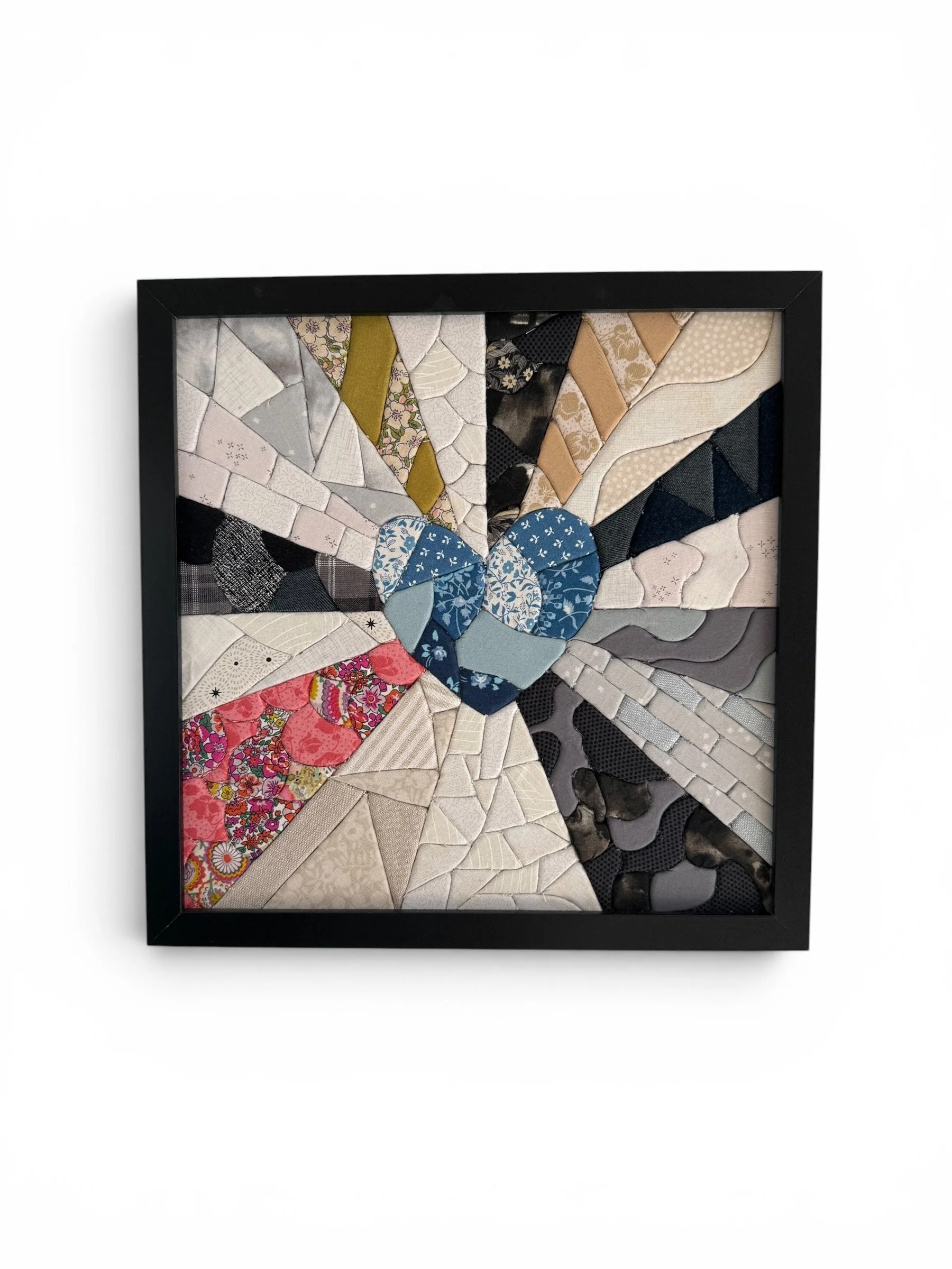 A patchwork style heart made in Kinusaiga technique with radiating rays
