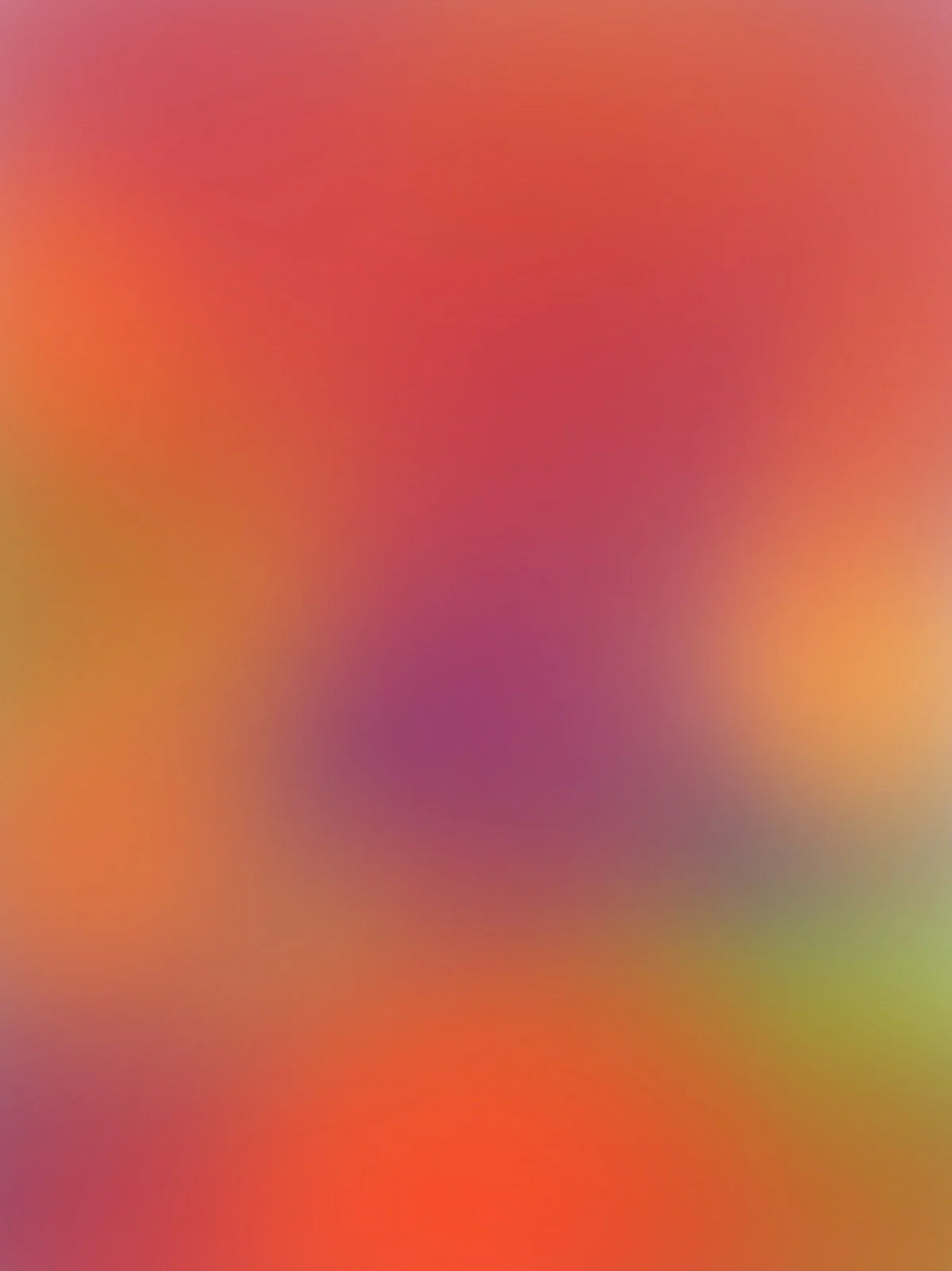 Blurred abstract background with warm colors including red, orange, yellow, pink, and purple.