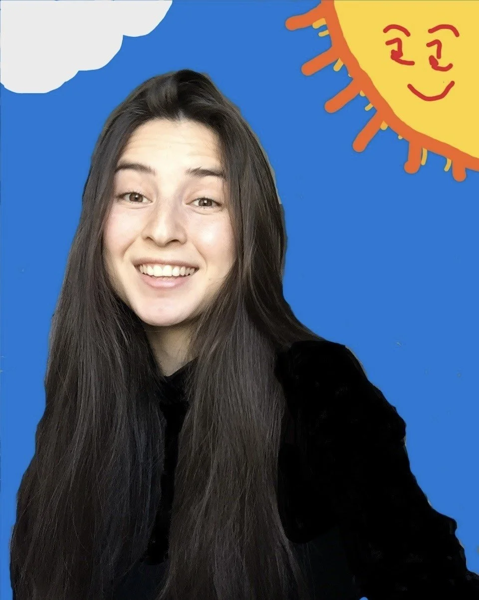 A young woman with long dark hair smiling at the camera against a blue background with cartoon sun and cloud illustrations.