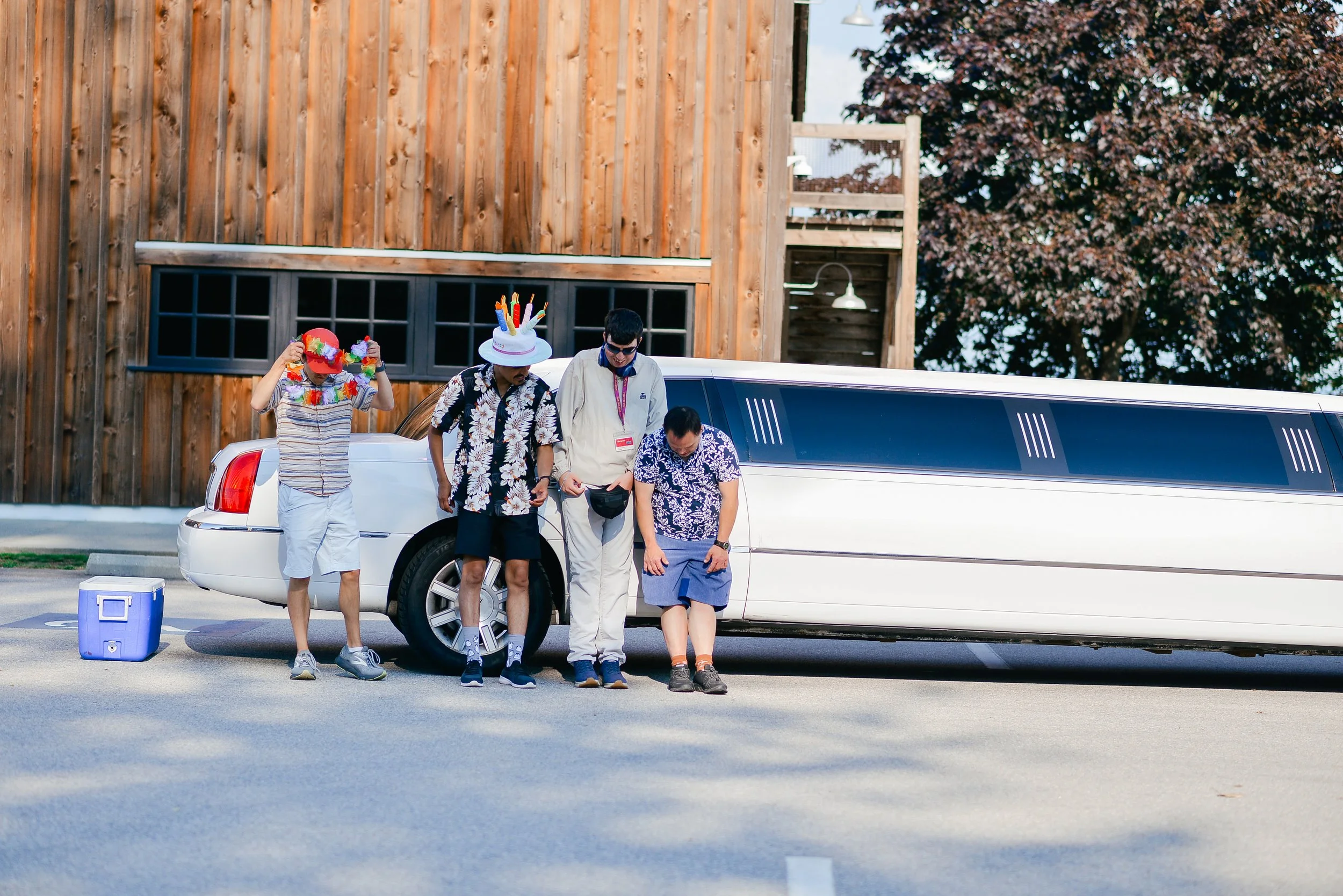 Image of 4 people next to limo