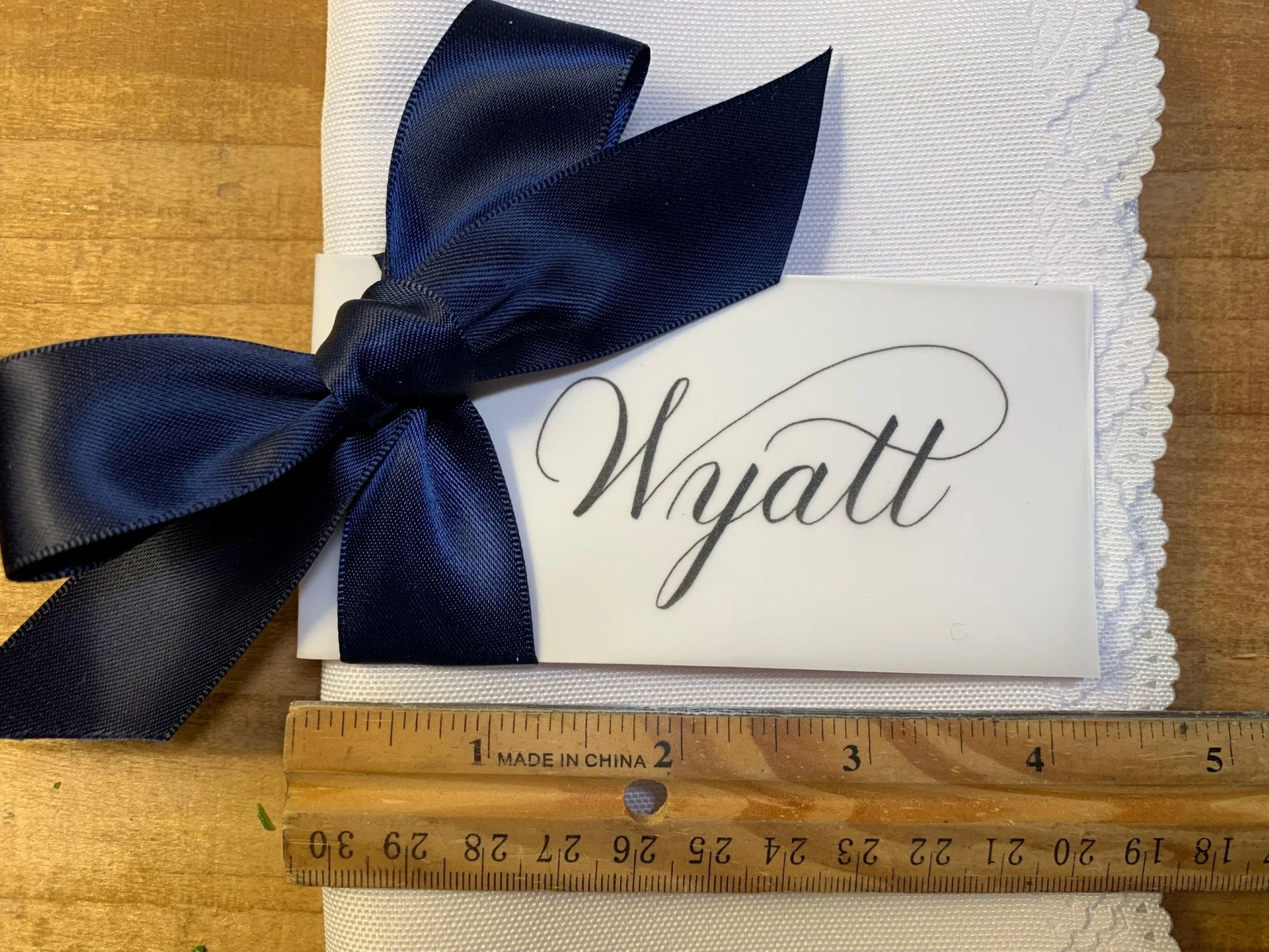 Navy blue ribbon place card with calligraphy of first name for party event