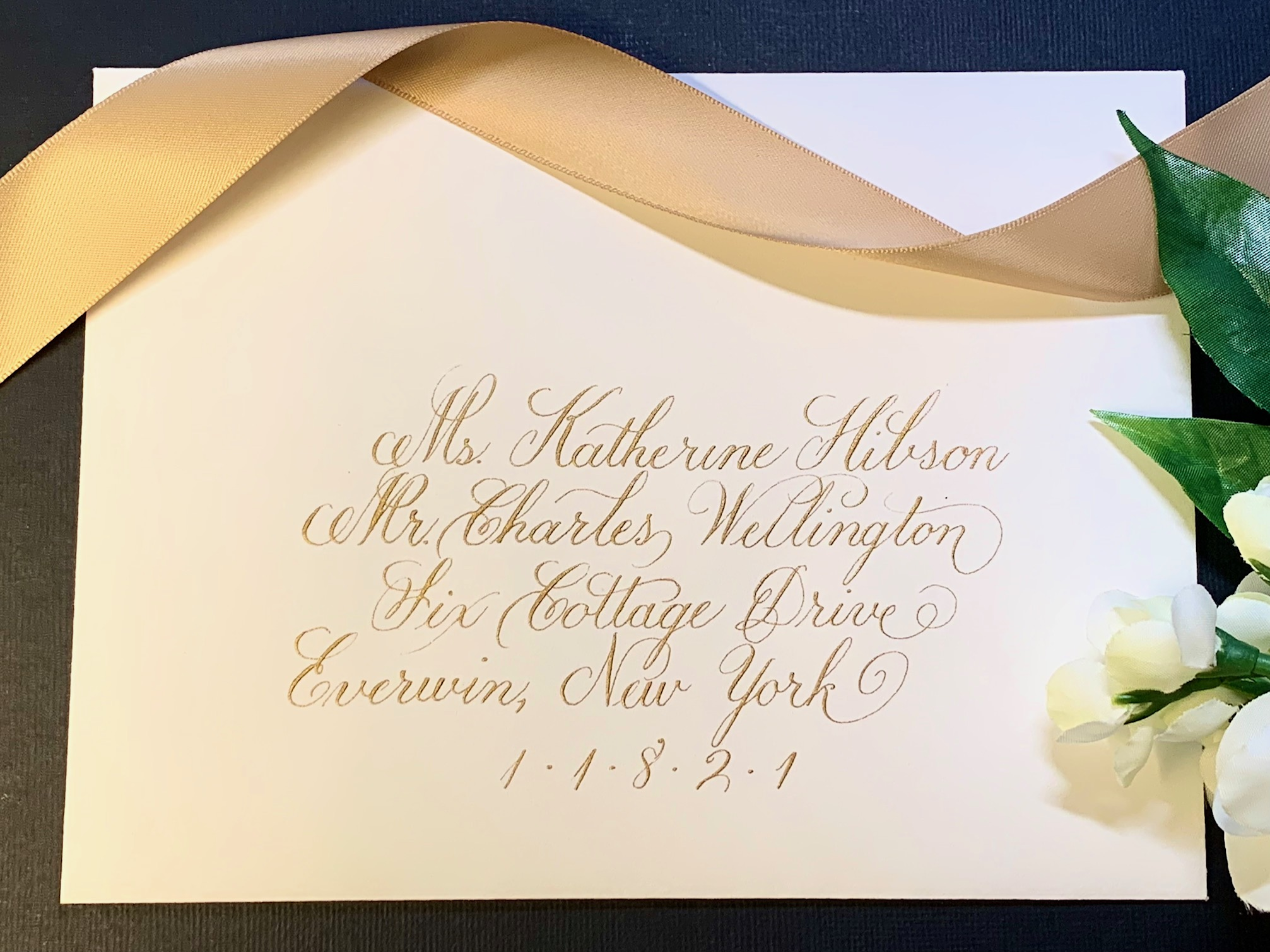 Gold ink calligraphy on wedding invitation that is addressed formally.