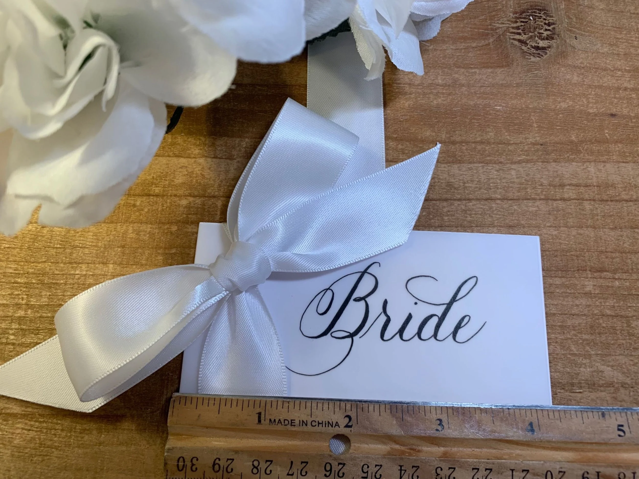 White bow place card with calligraphy for wedding