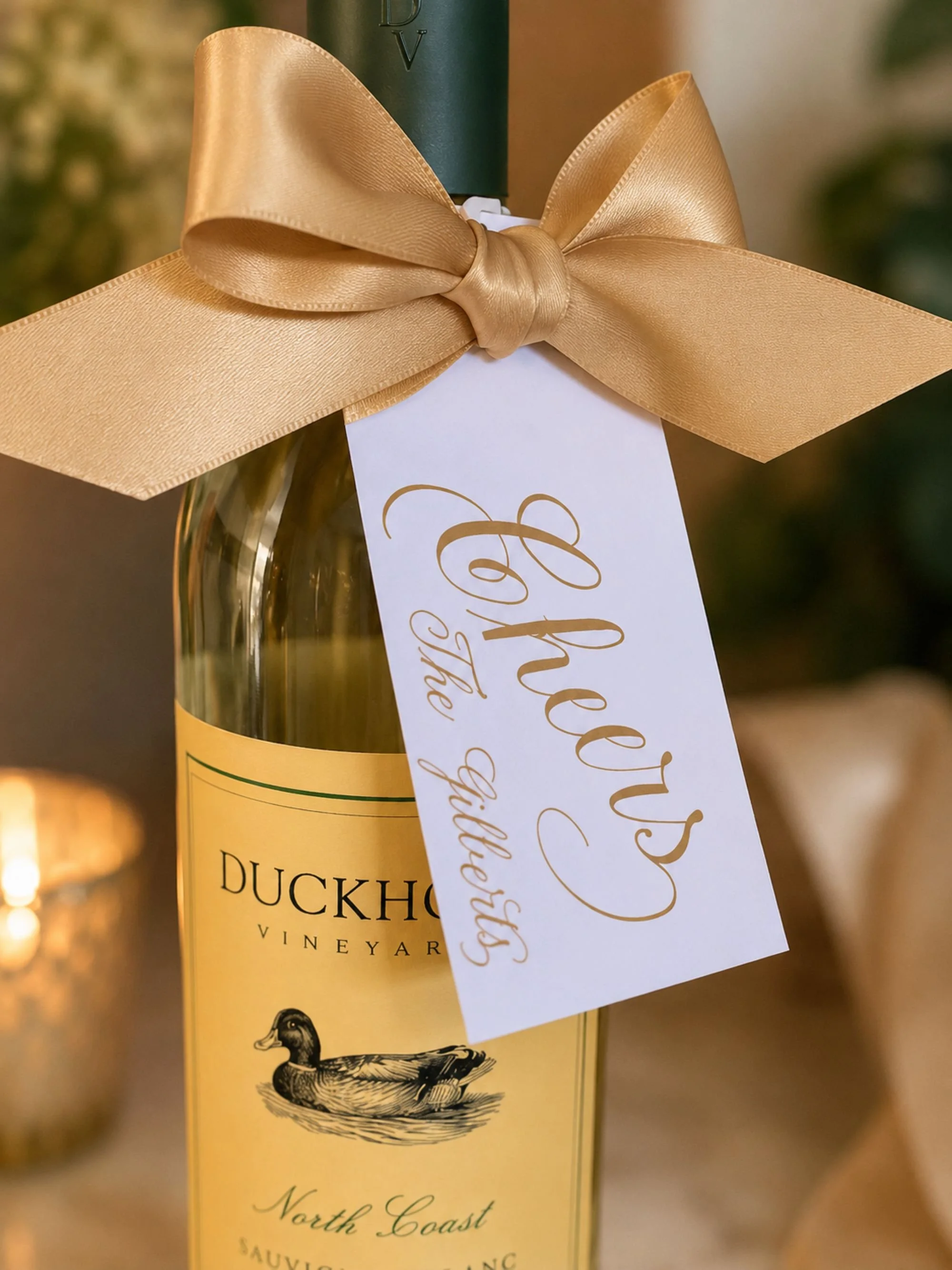 Gold ribbon gift tags with custom gold ink calligraphy for wine bottle for weddings or special events.