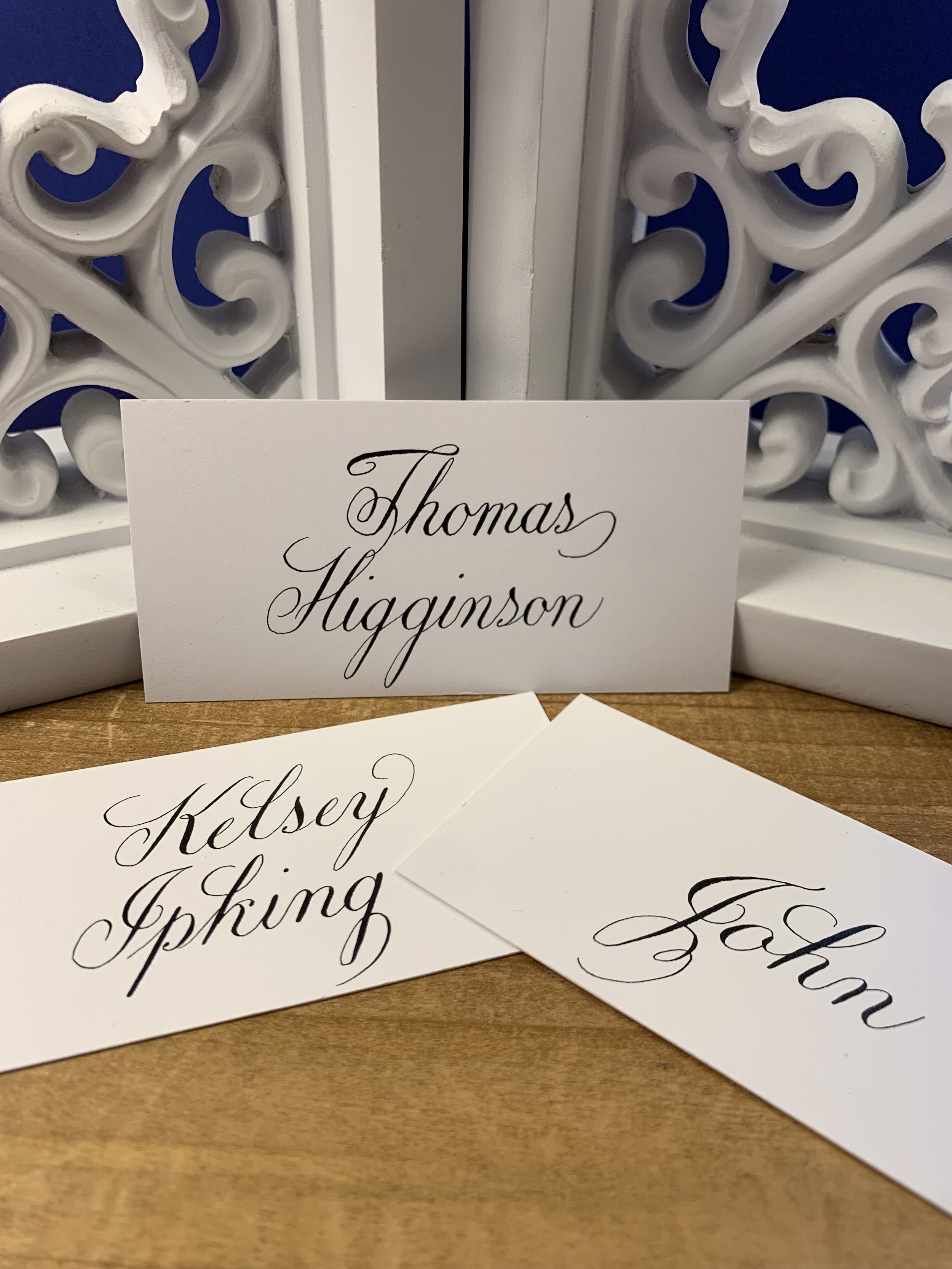 Elegant formal wedding calligraphy place cards with black ink of first or full names.