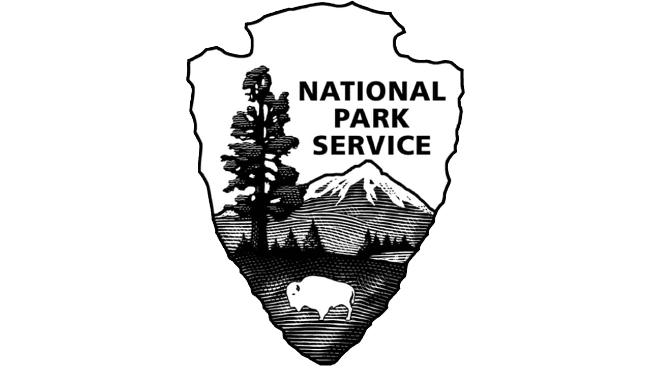 Black and white image of the National Park Service emblem featuring a mountain, a tree, and a bison with text 'National Park Service'.