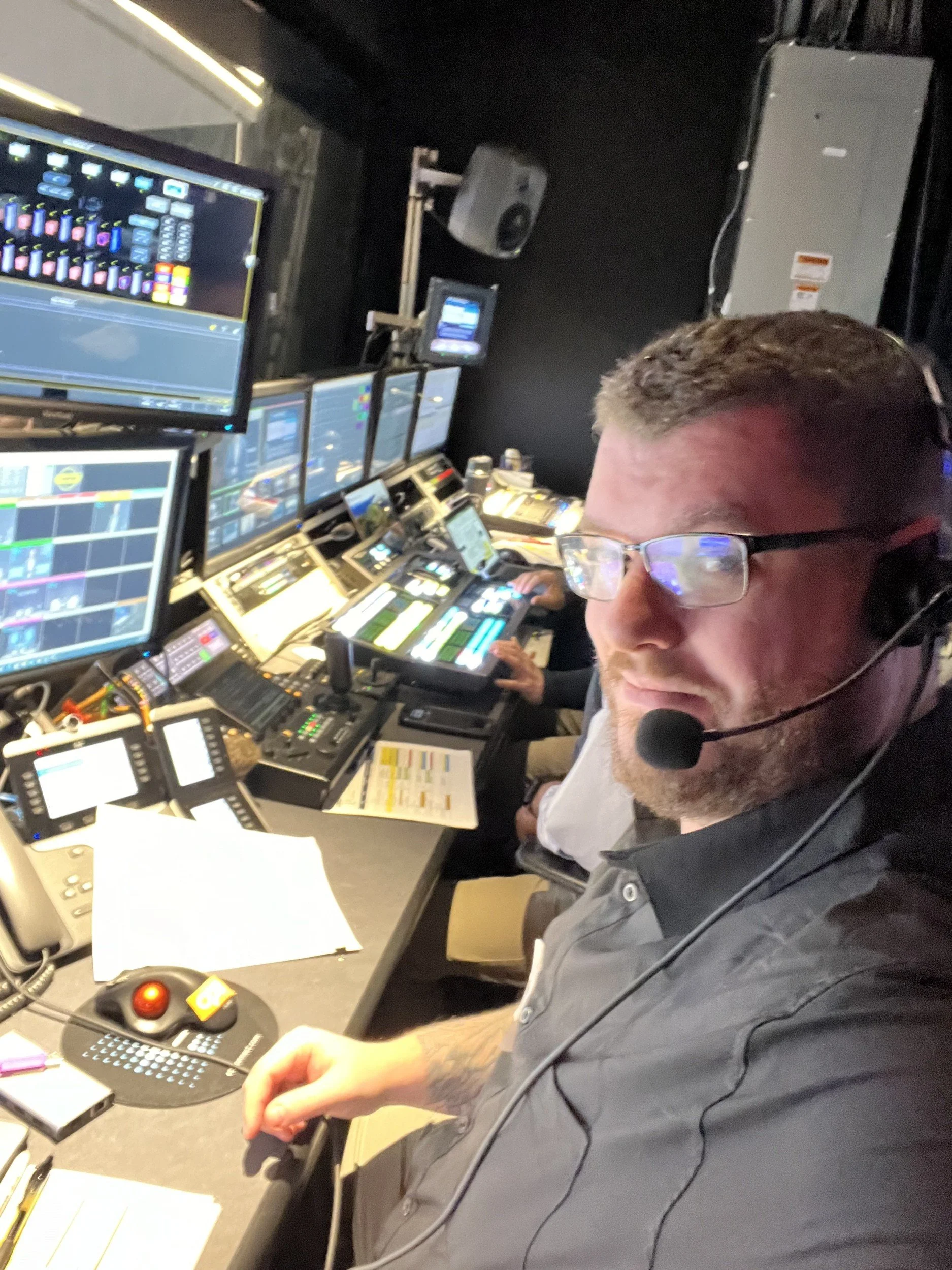 Jacob in the control room on headset, keeping the show on cue