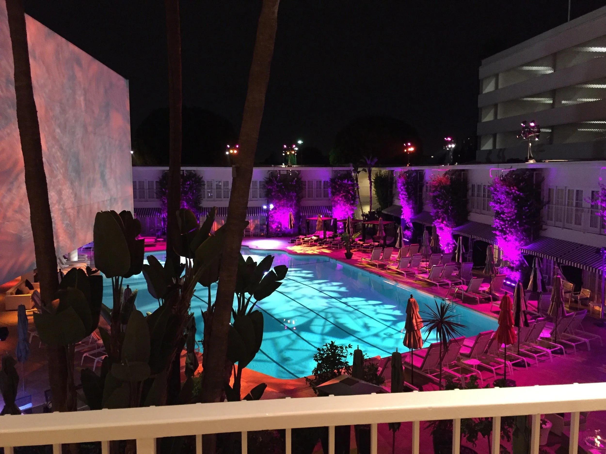 Hospitality activation: poolside gobo wash, uplit palms and a projection wall, Beverly Hills