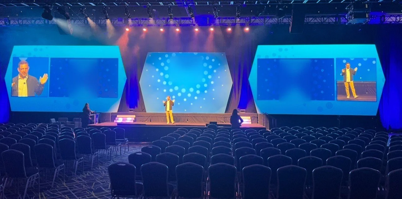Corporate general session: custom hex LED surrounds, three screen IMAG and full theater seating