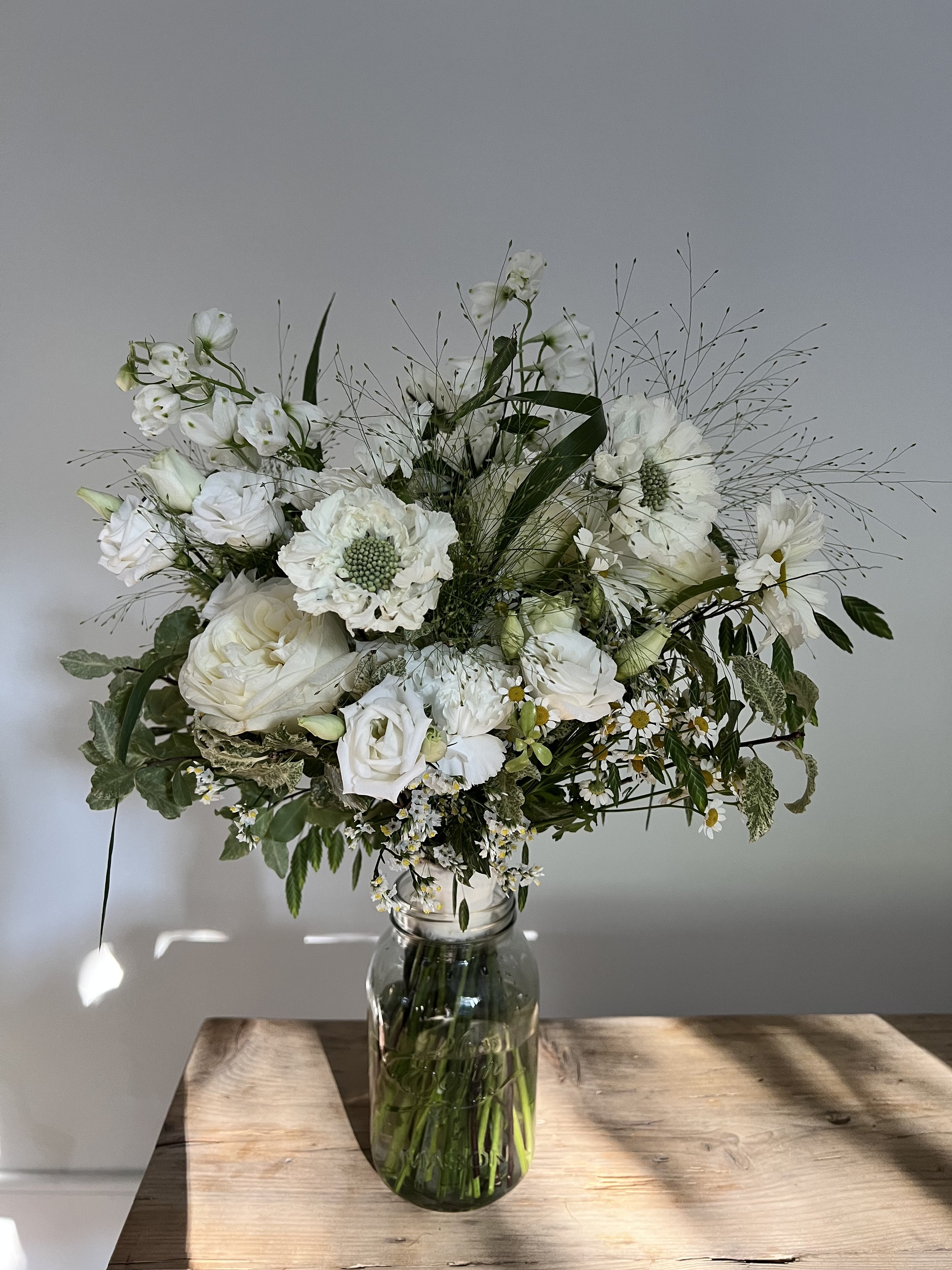 Delicate and wispy meadow style featuring Scabious, Grasses, Daisies and Lisianthus