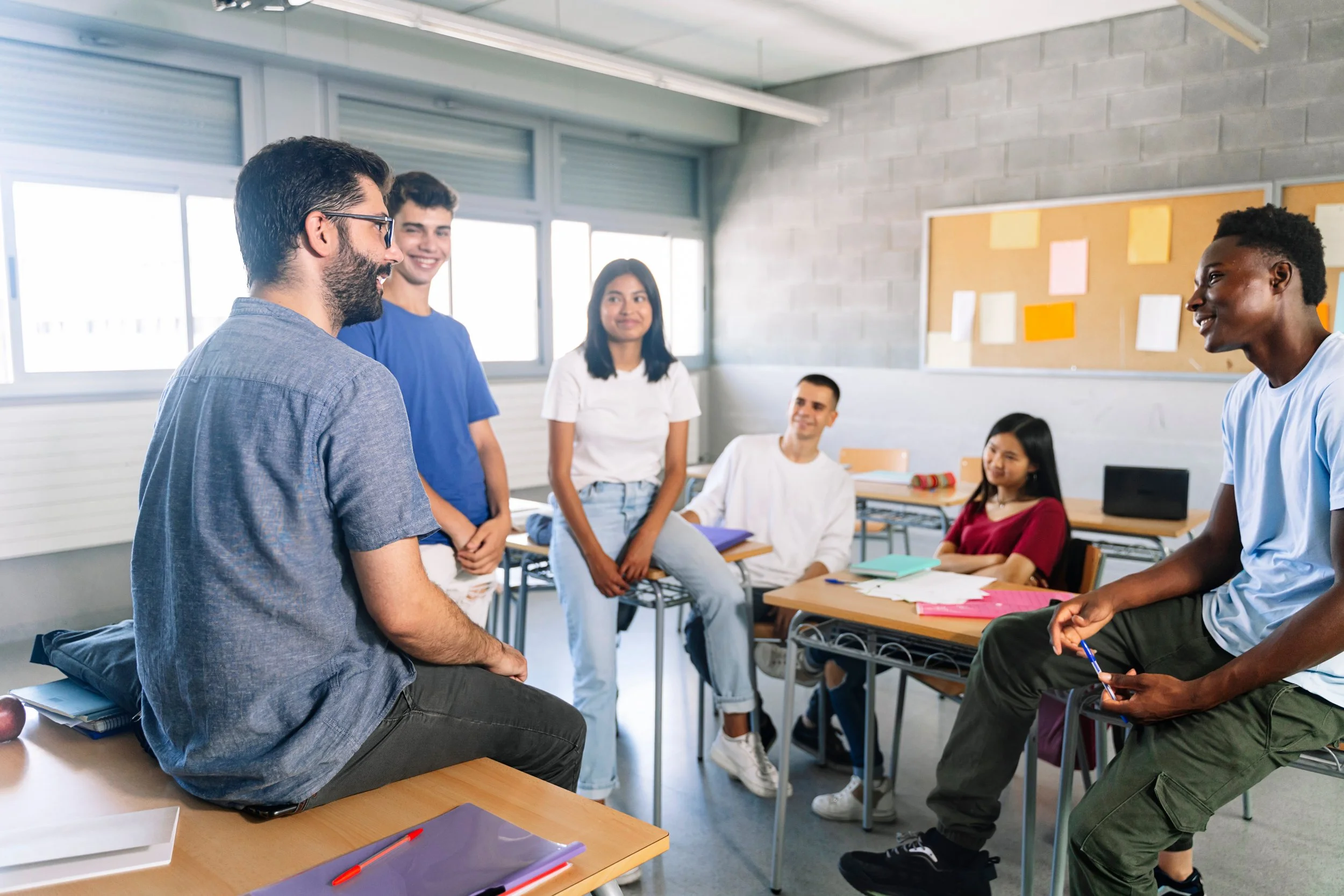 School Counselor talking to young adults in a classroom