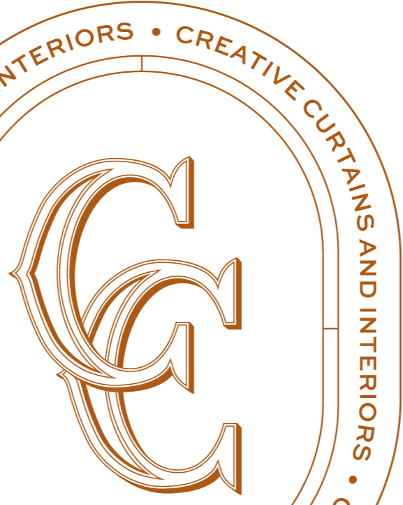 Logo with large stylized letters 'CC' in the center. Surrounding text reads 'INTERIORS · CREATIVE CURATING AND INTERIORS' in a circular pattern. The logo is copper-colored on a black background.