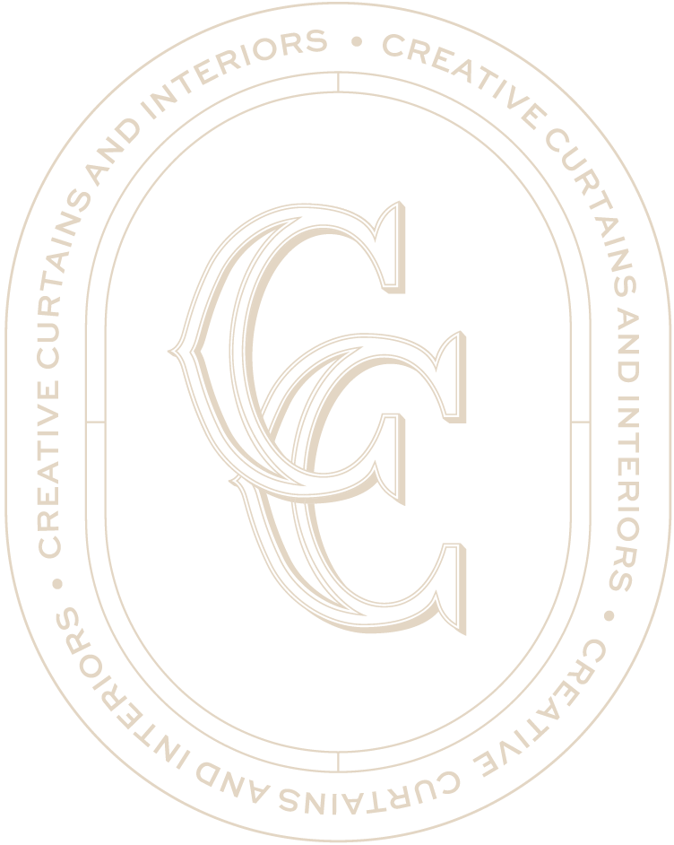 A beige circular logo with the text 'CREATIVE CURTAINS AND INTERIORS' repeated around the perimeter. Inside the circle, there is a stylized, intertwined 'C' and 'I' in a matching beige color.