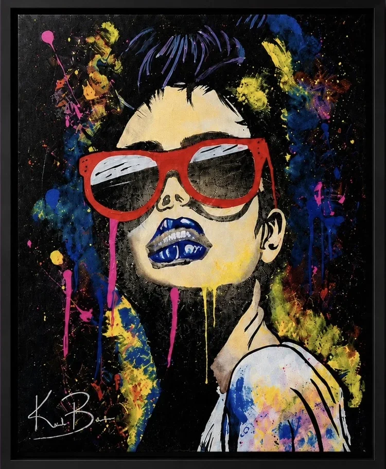 A vibrant, abstract painting of a woman with dark hair, wearing red sunglasses, with colorful splashes of paint all around. She has blue lips and is set against a black background.