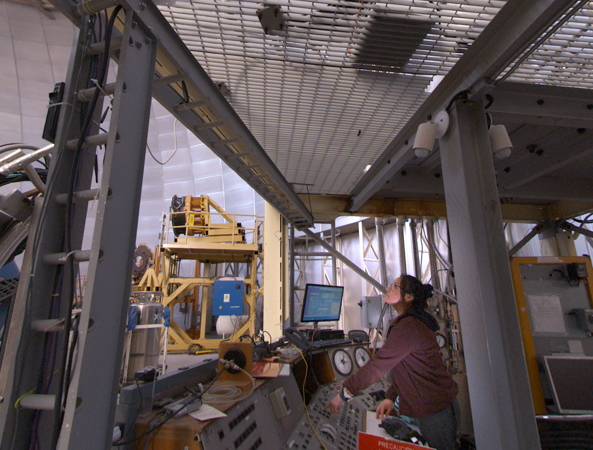 Jacqueline Seron, Assistant Observer at the Cerro Tololo Interamerican Observatory (CTIO),
prepares the Victor M. Blanco Telescope for a night of observations. | California Academy of Sciences