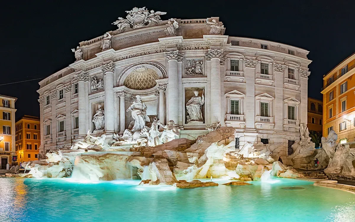 Panoramic evening view of the Trevi Fountain in Rome, Italy, representing ImmerseMe's immersive Italian language learning experiences inspired by authentic Italian culture and real-world locations.