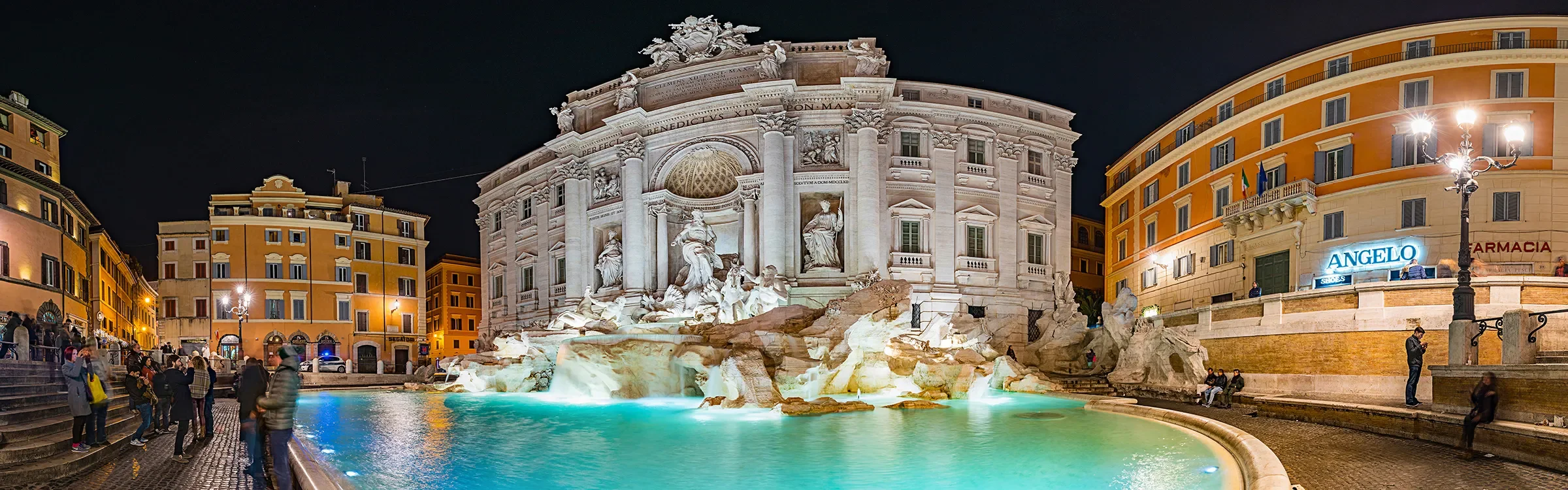 Panoramic evening view of the Trevi Fountain in Rome, Italy, representing ImmerseMe's immersive Italian language learning experiences inspired by authentic Italian culture and real-world locations.