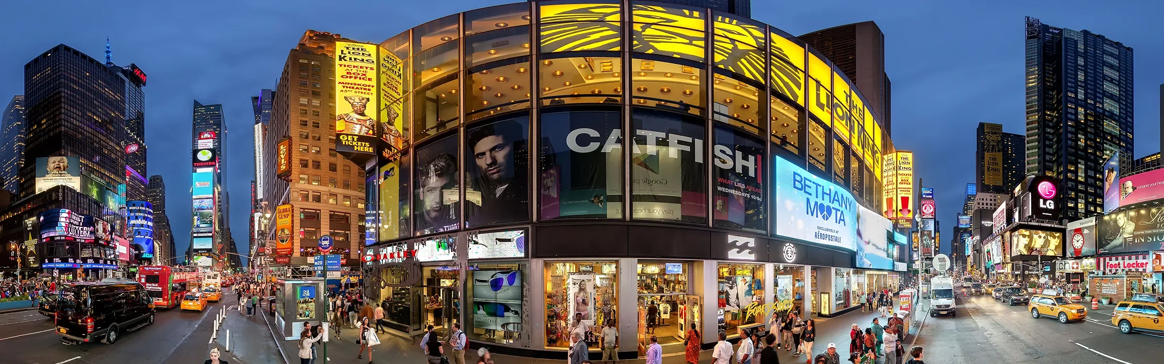 Panoramic evening view of Times Square in New York City, representing ImmerseMe's immersive English language learning experiences inspired by authentic real-world locations.