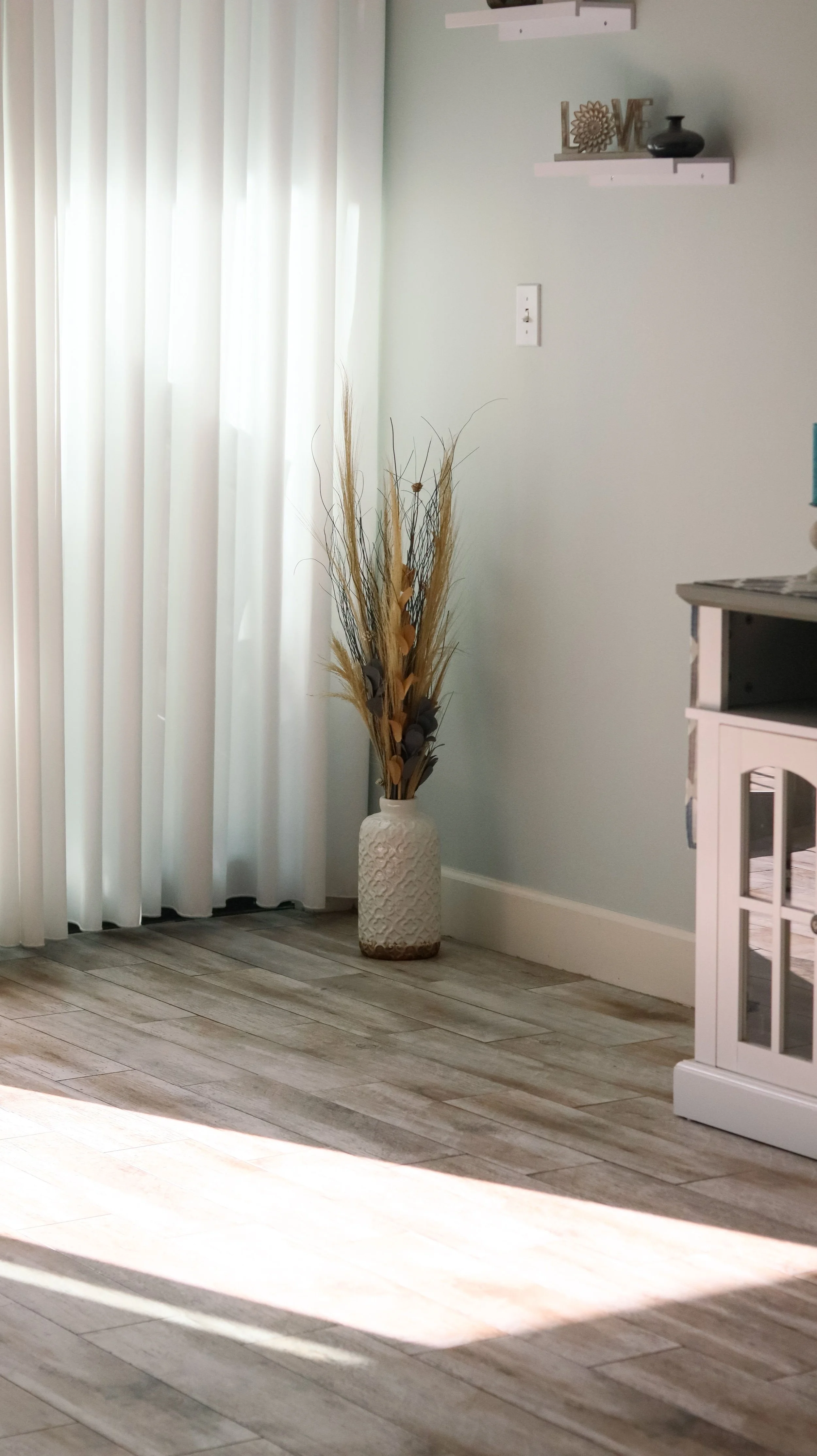 Gray luxury vinyl plank flooring installed in a Utah living room