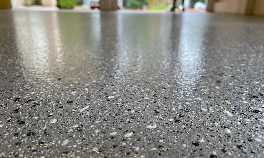 Close-up view of a textured gray concrete or stone surface.