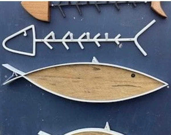 Decorative fish skeleton and fish shape made of metal and wood.
