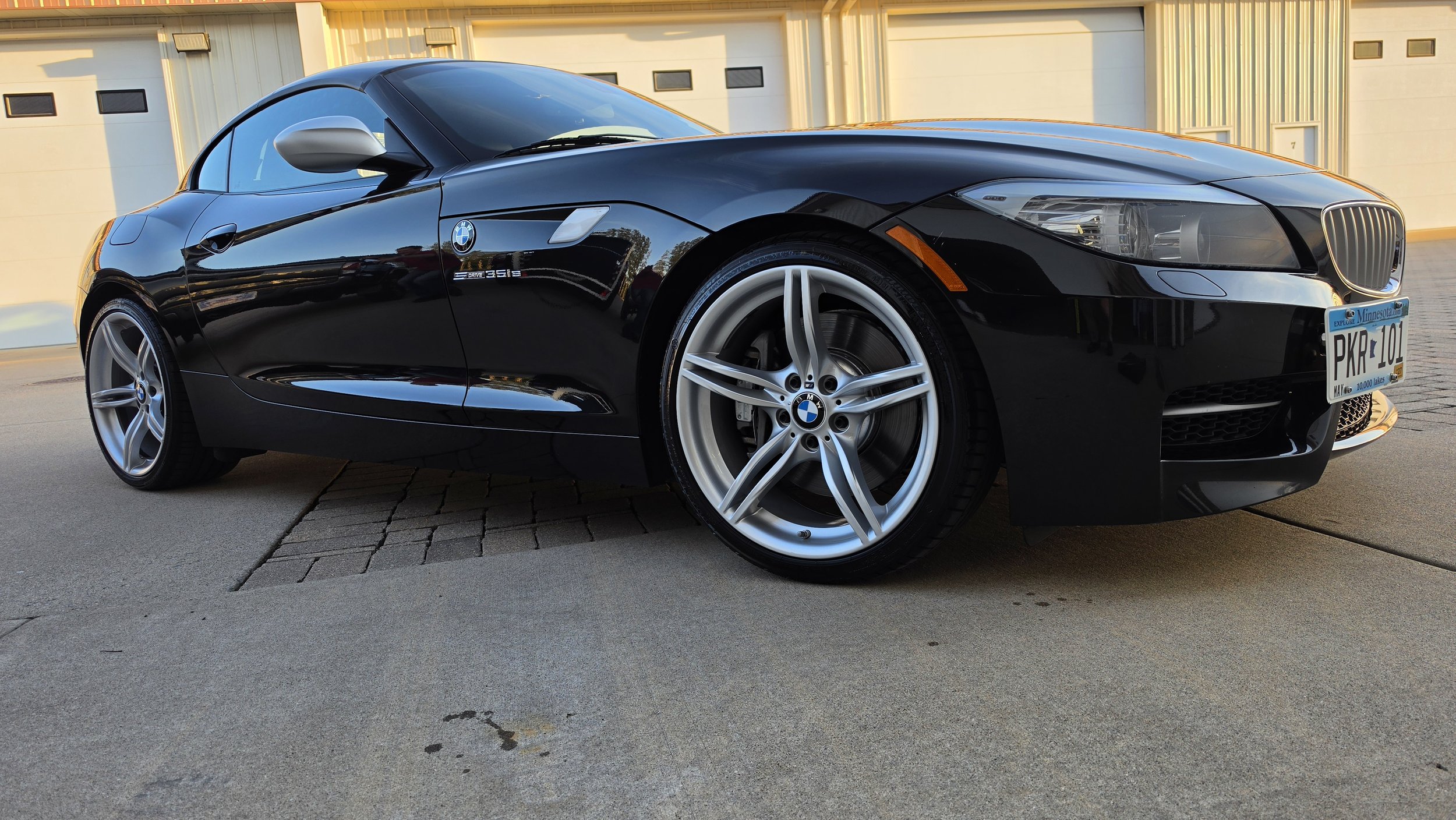 A paint corrected BMW sports car with all the scratches removed and a glossy polishing, that is ceramic coated and very clean