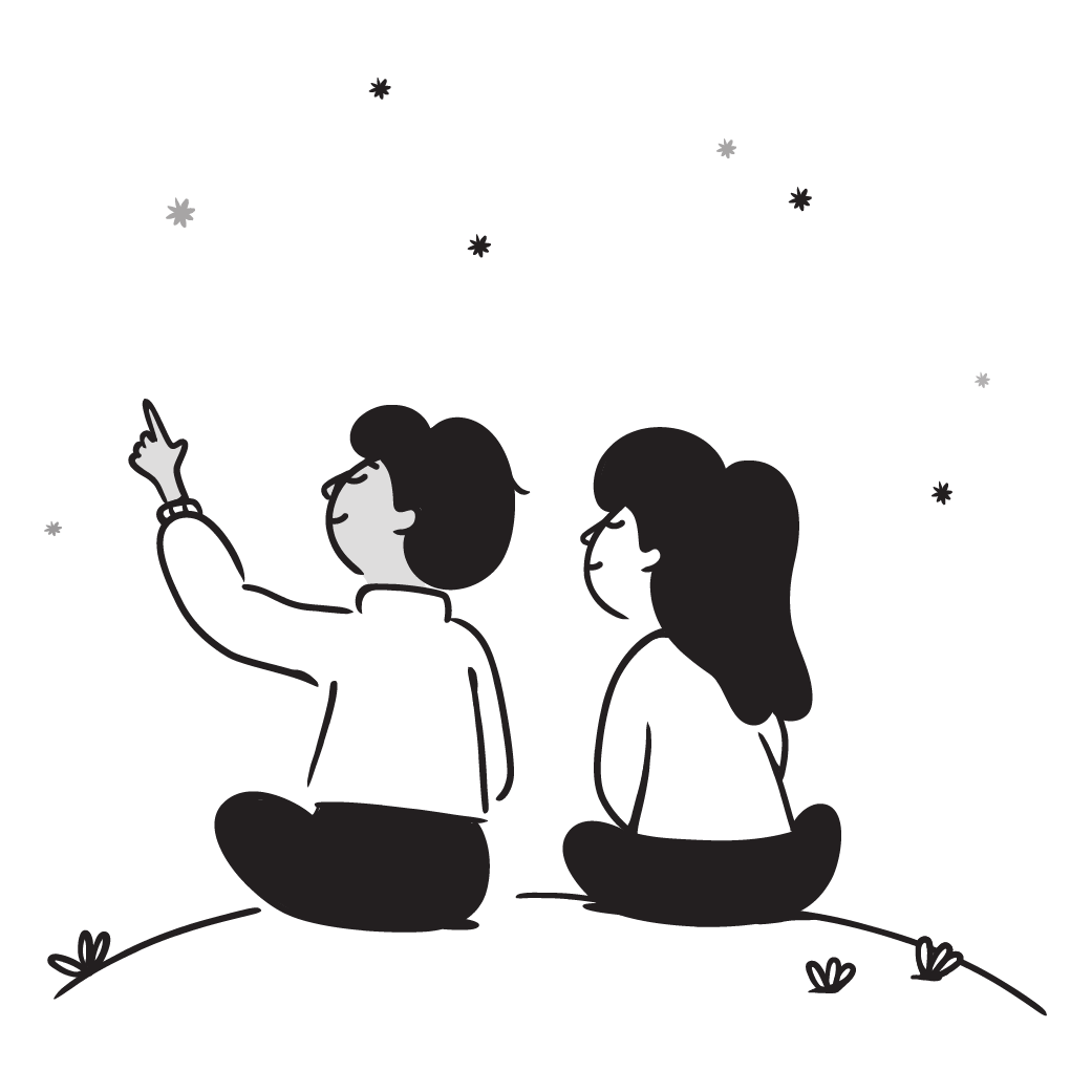 Silhouette of a boy and girl sitting on grass and watching stars in the night sky, with one child pointing at the stars.