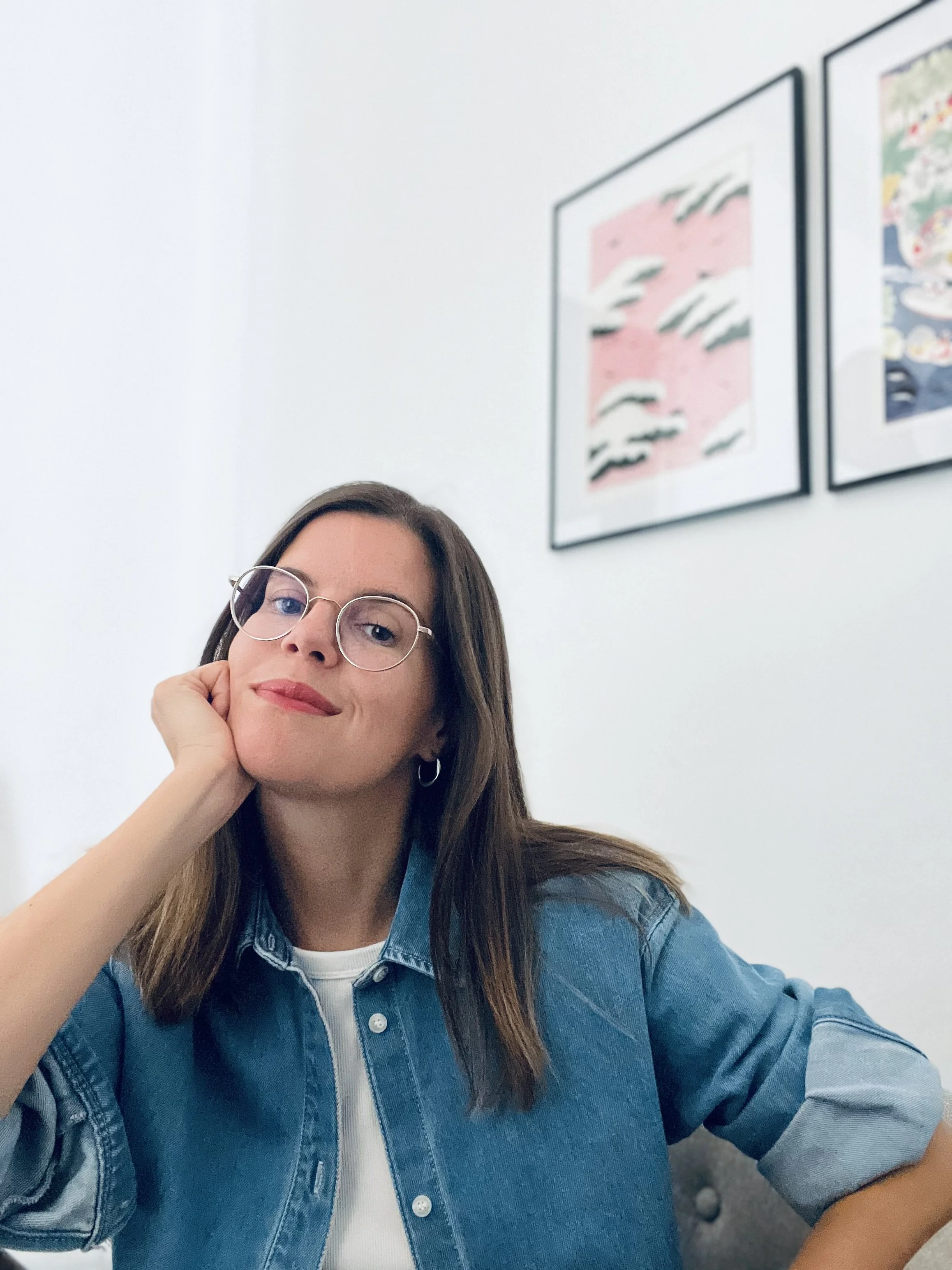 Charlotte Perhirin, fashion and luxury copywriter based in Barcelona, wearing a denim jacket, photographed in her studio.