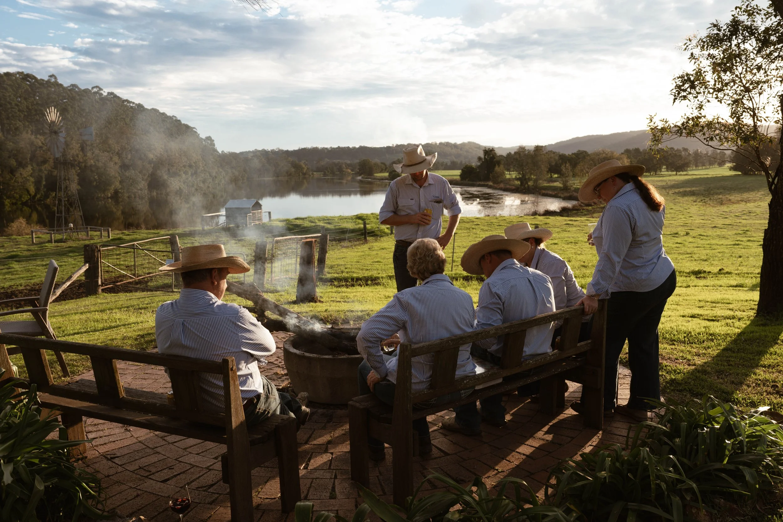 The Boambee team, relaxing around the fire on their property at East Seaham, NSW. 