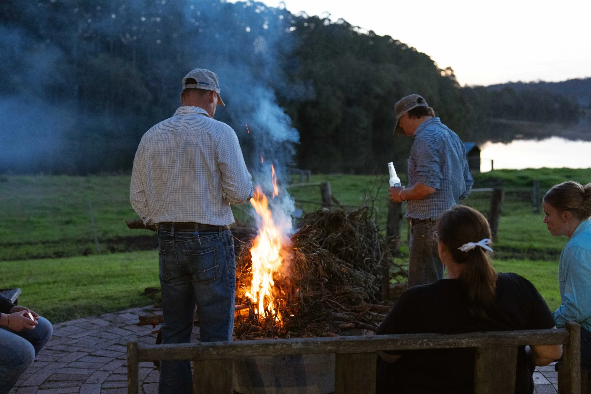 The Boambee team, relaxing around the fire on their property at East Seaham, NSW. 
