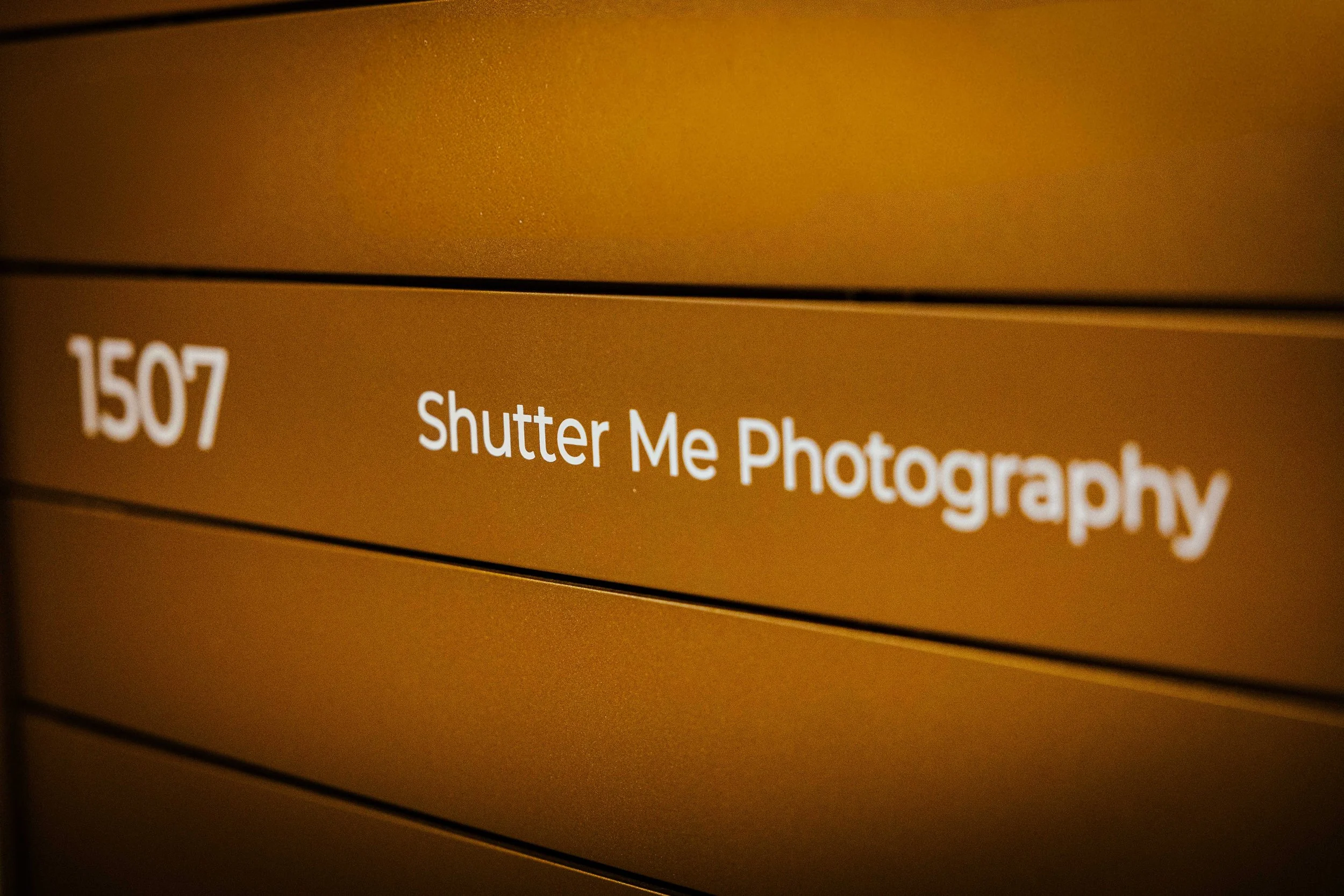 Close-up of a computer screen displaying a photo editing application with text '150/ Shutter Me Photography'.