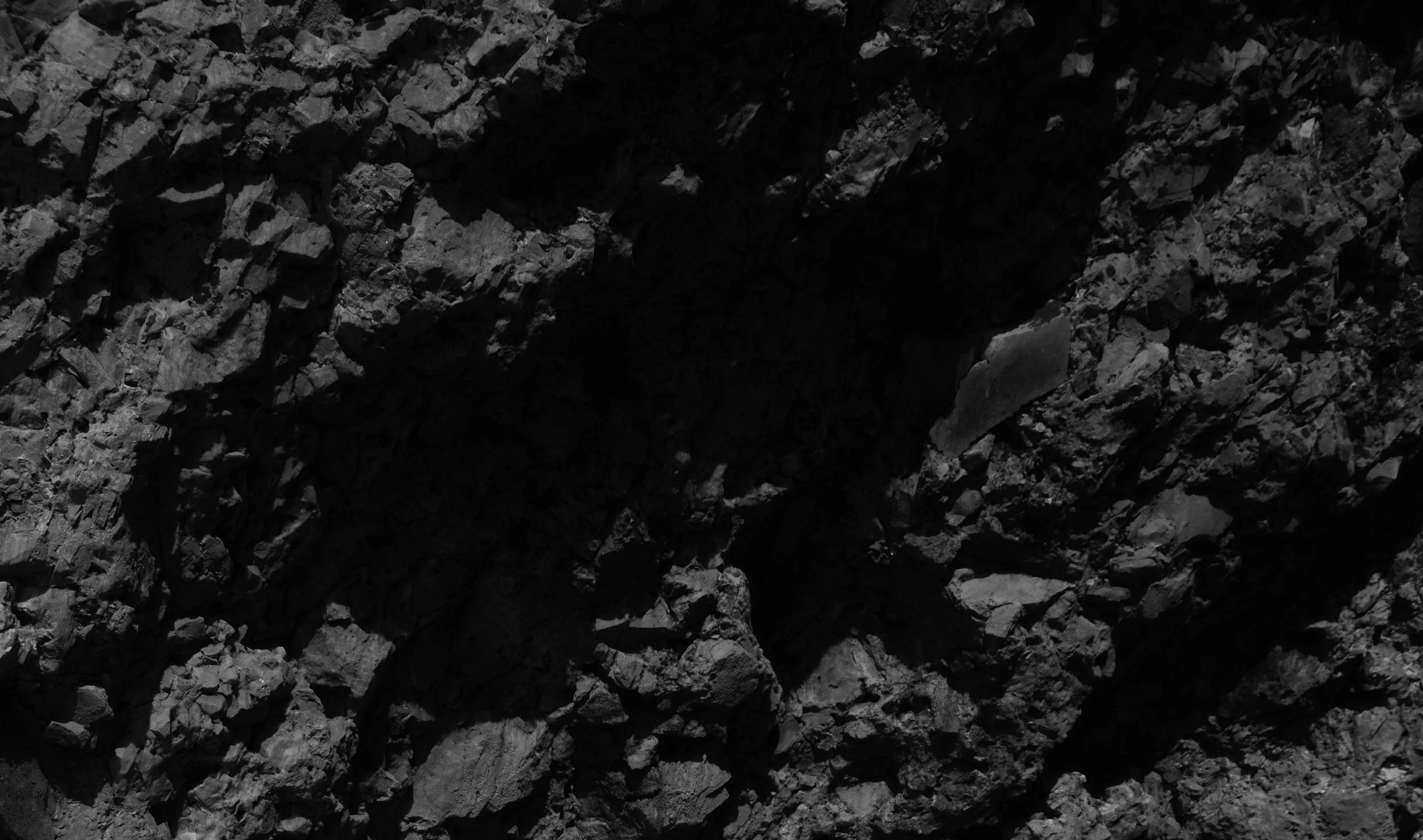 Close-up of a dirt or gravel surface with small rocks and uneven texture