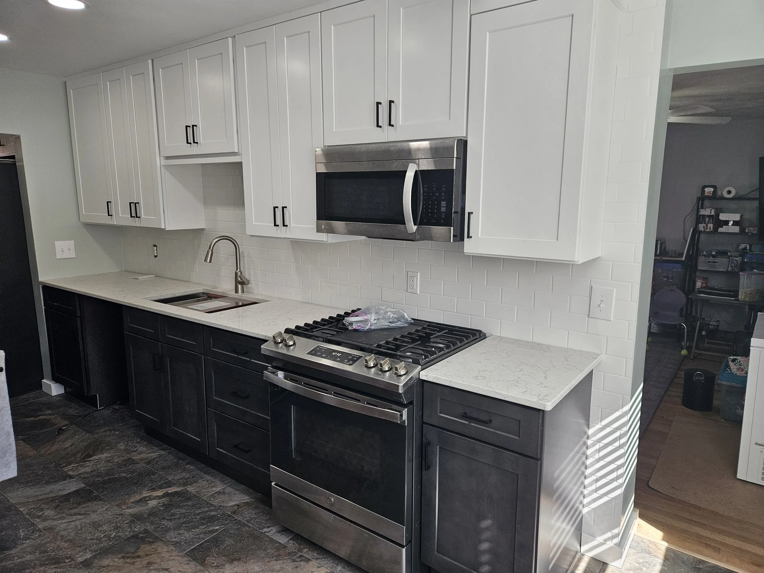 We installed cabinets, tile floor, tile backsplash, and trim.