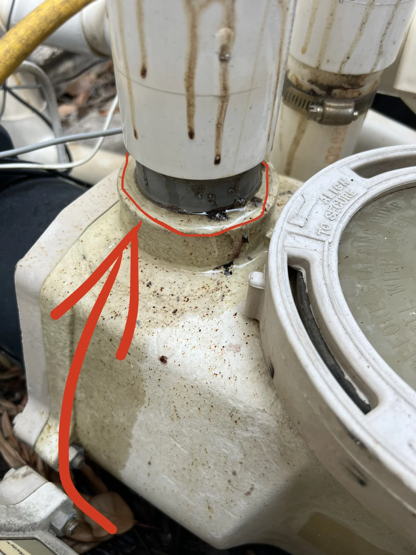 Close-up of a dirty, stained overfilled coffee machine water reservoir with rust and build-up, with orange lines outlining the area of concern.