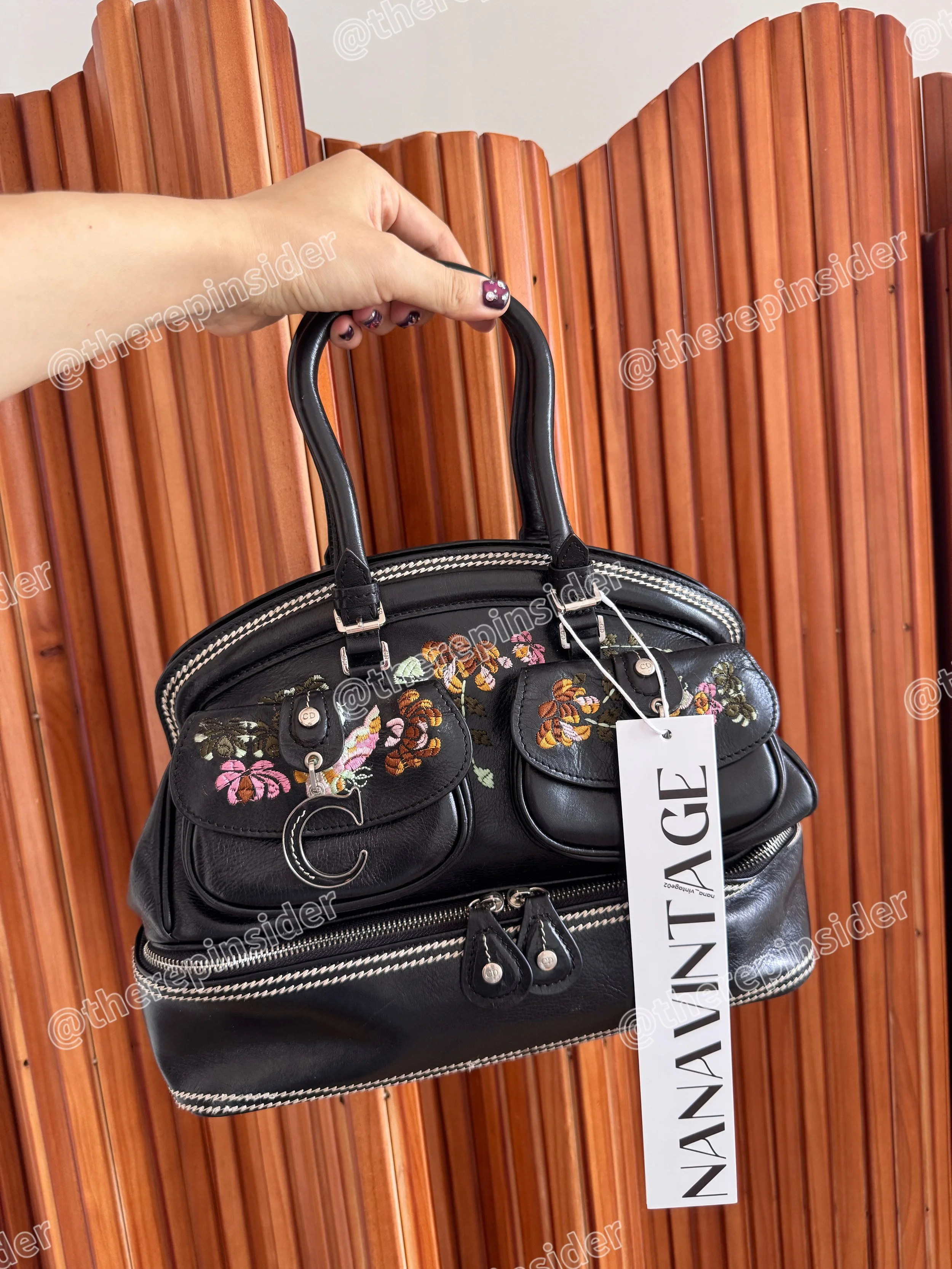 Close-up of rare John Galliano era Dior black floral embroidered handbag with silver CD charms⁠