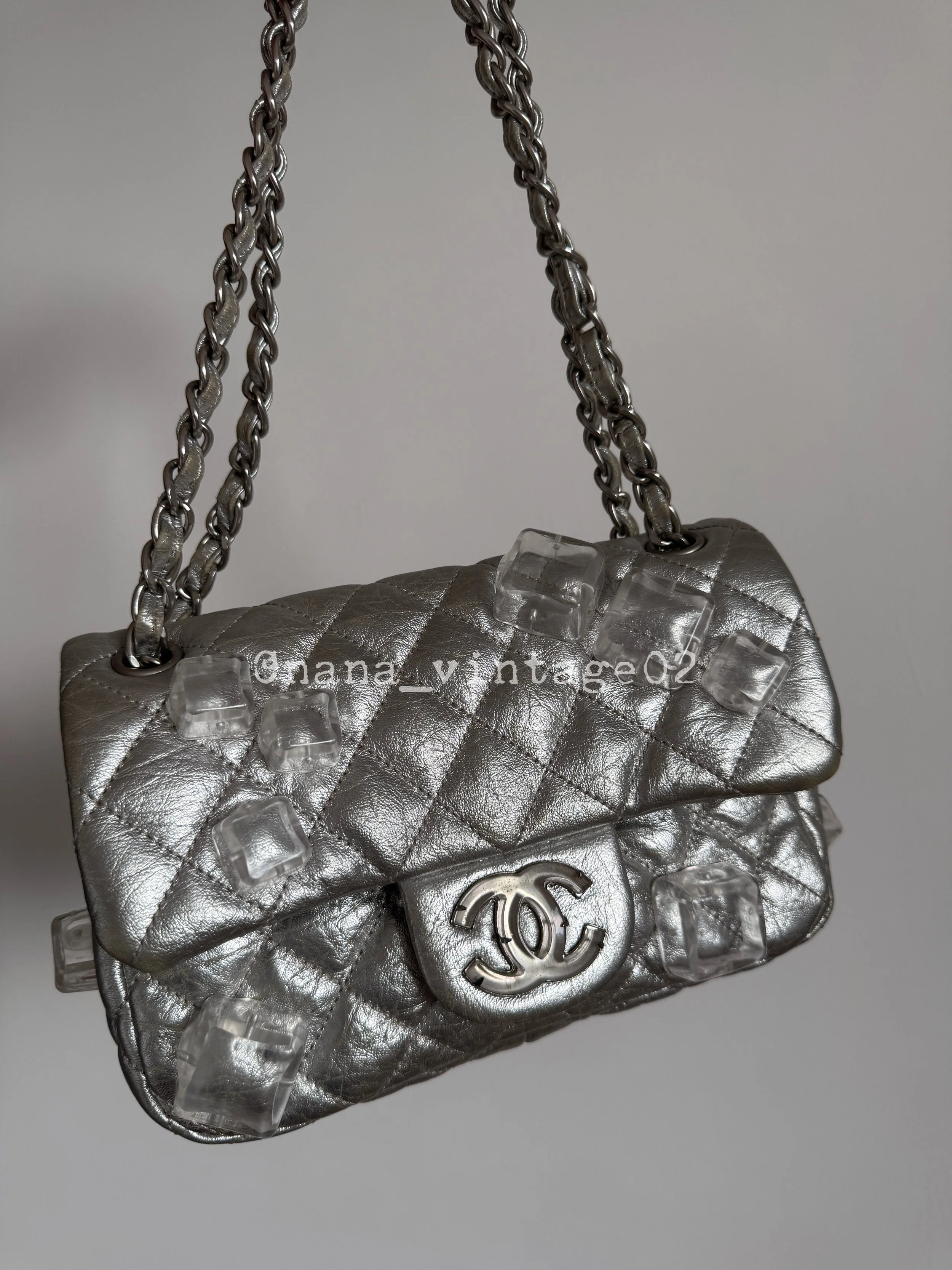 A rare Chanel vintage and archive replica silver metallic leather classic flap bag featuring unique transparent ice-cube embellishments, a quilted texture, and silver-tone hardware.⁠