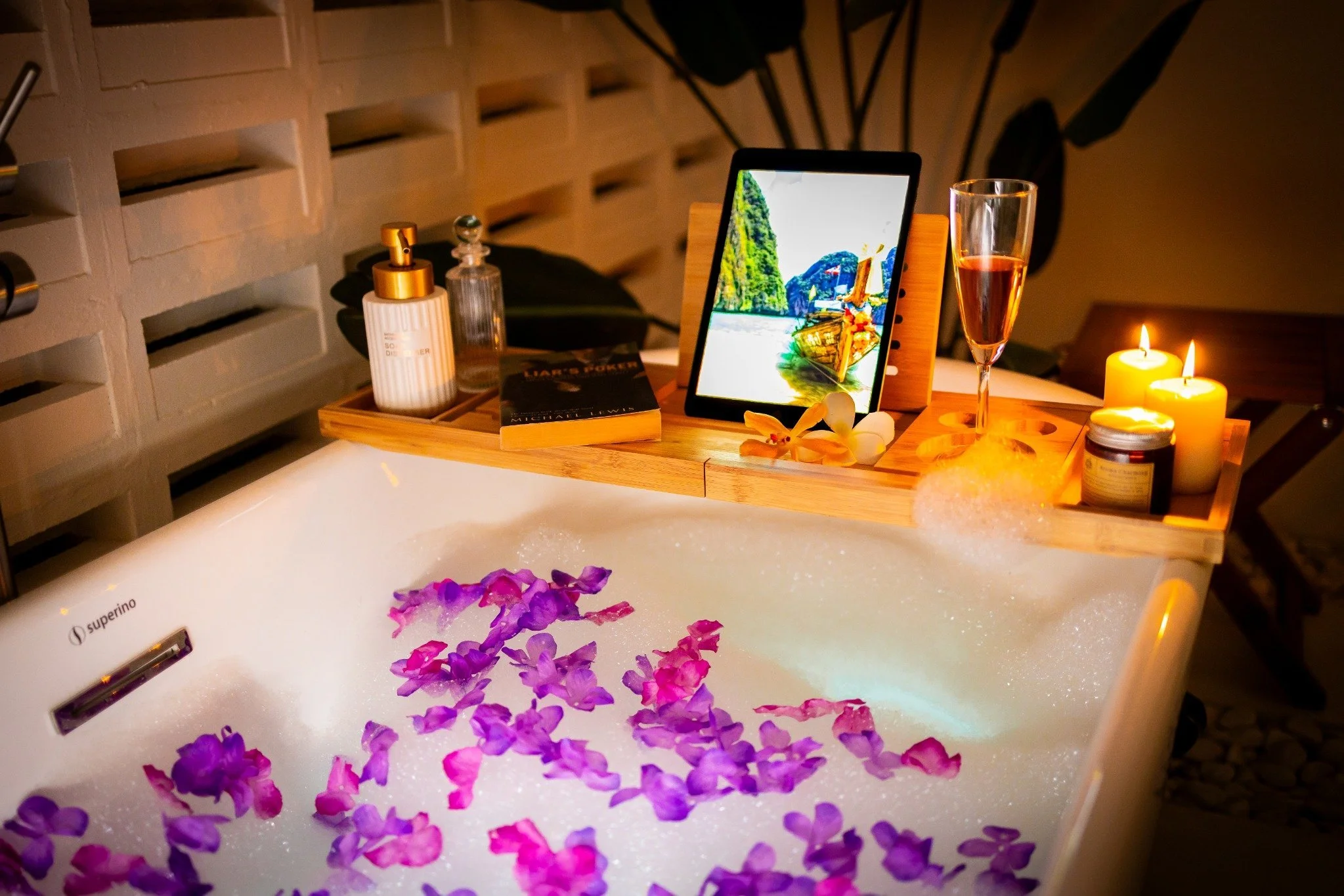 Freestanding bath sanctuary — capiz chandelier, pebble floor, glass