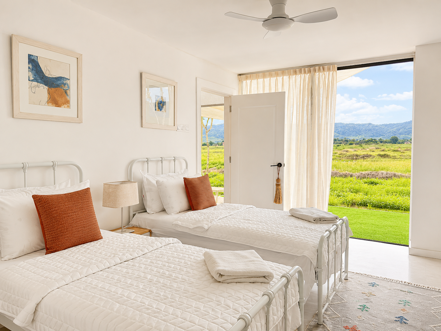 Second bedroom — twin beds, soft linens and paddy fields & mountain views