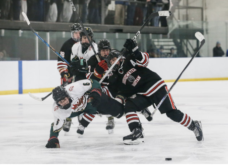 Hockey players battling for puck on ice rink