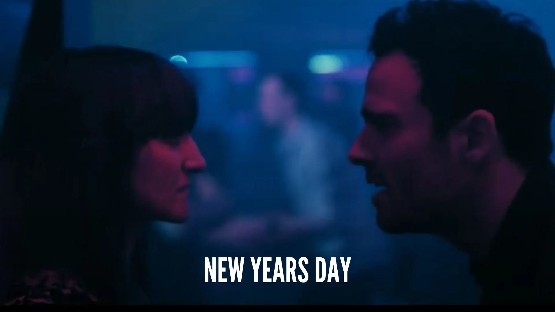 Two people face each other closely in a dimly lit setting with neon blue and purple lights, with the text 'New Year's Day' at the bottom.
