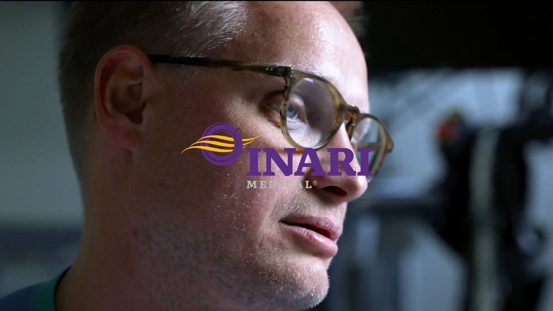 Close-up of a man wearing glasses with the Inari Medical logo overlaid on the image.