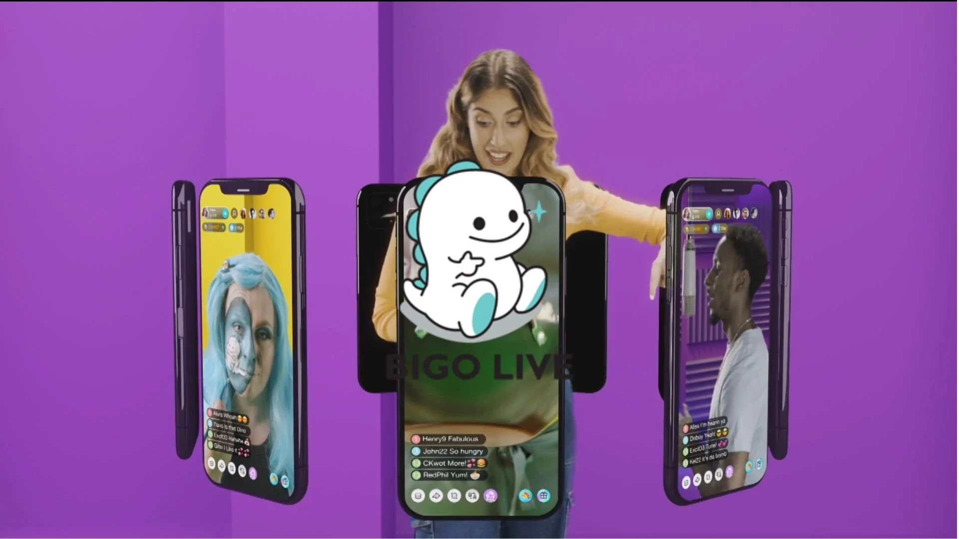 A woman presents several smartphones with live social media videos, featuring diverse individuals and colorful backgrounds, against a purple backdrop.