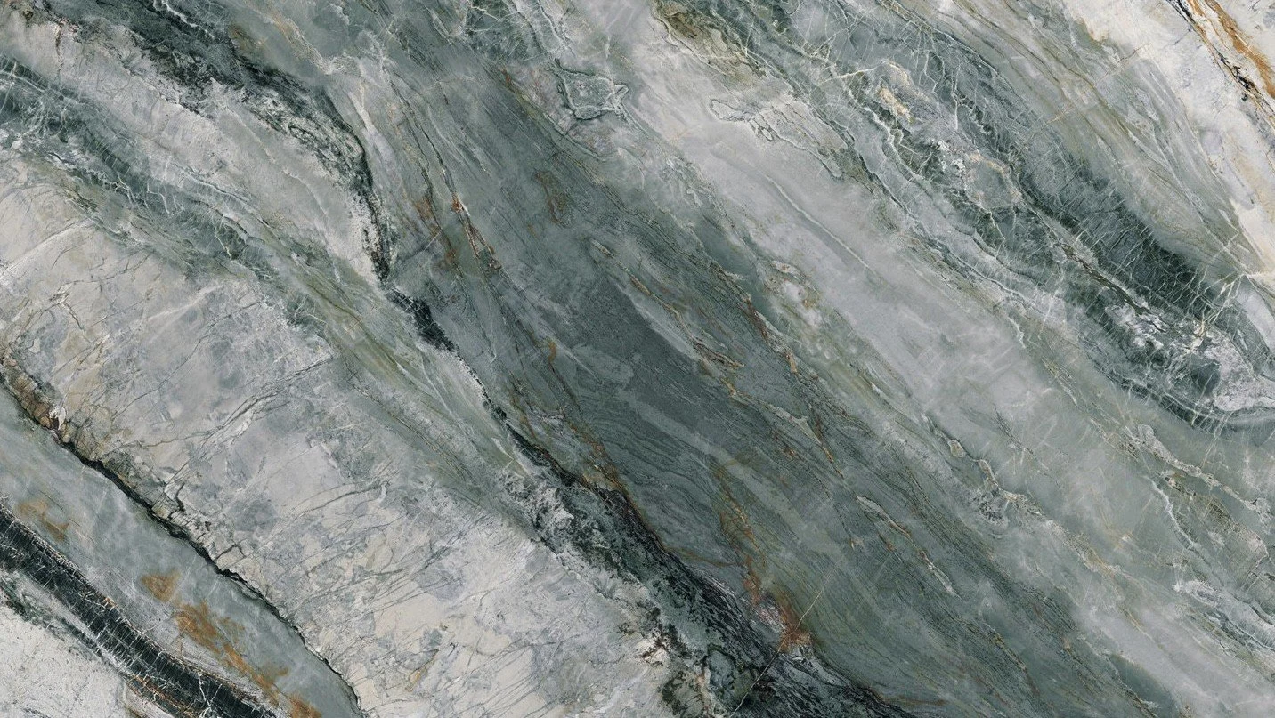 Close-up of a greenish-gray marble surface with various veining patterns.