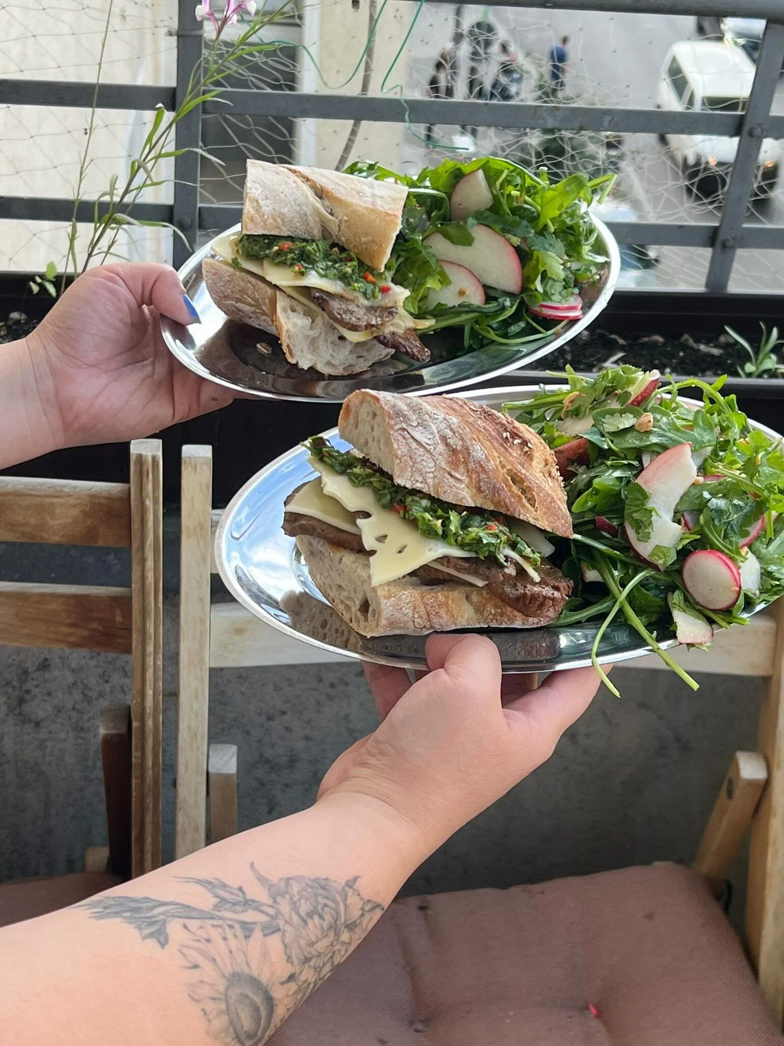 the healing meal i needed this week. 🥪 steak sandwiches with swiss cheese and chimichurri. arugula salad with nectarines, radishes, and marcona almonds.