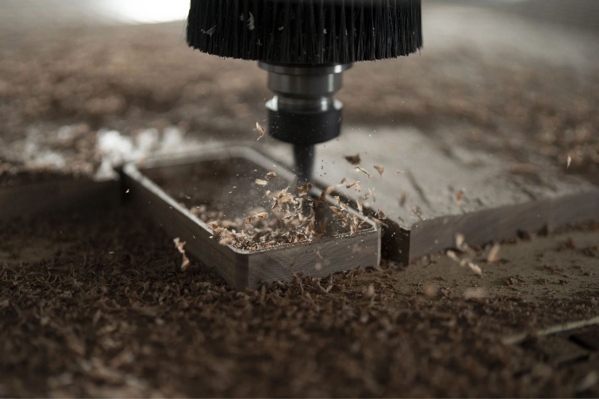 A drill pressing into a metal surface, creating shavings。」}loadbalanced0.1{
