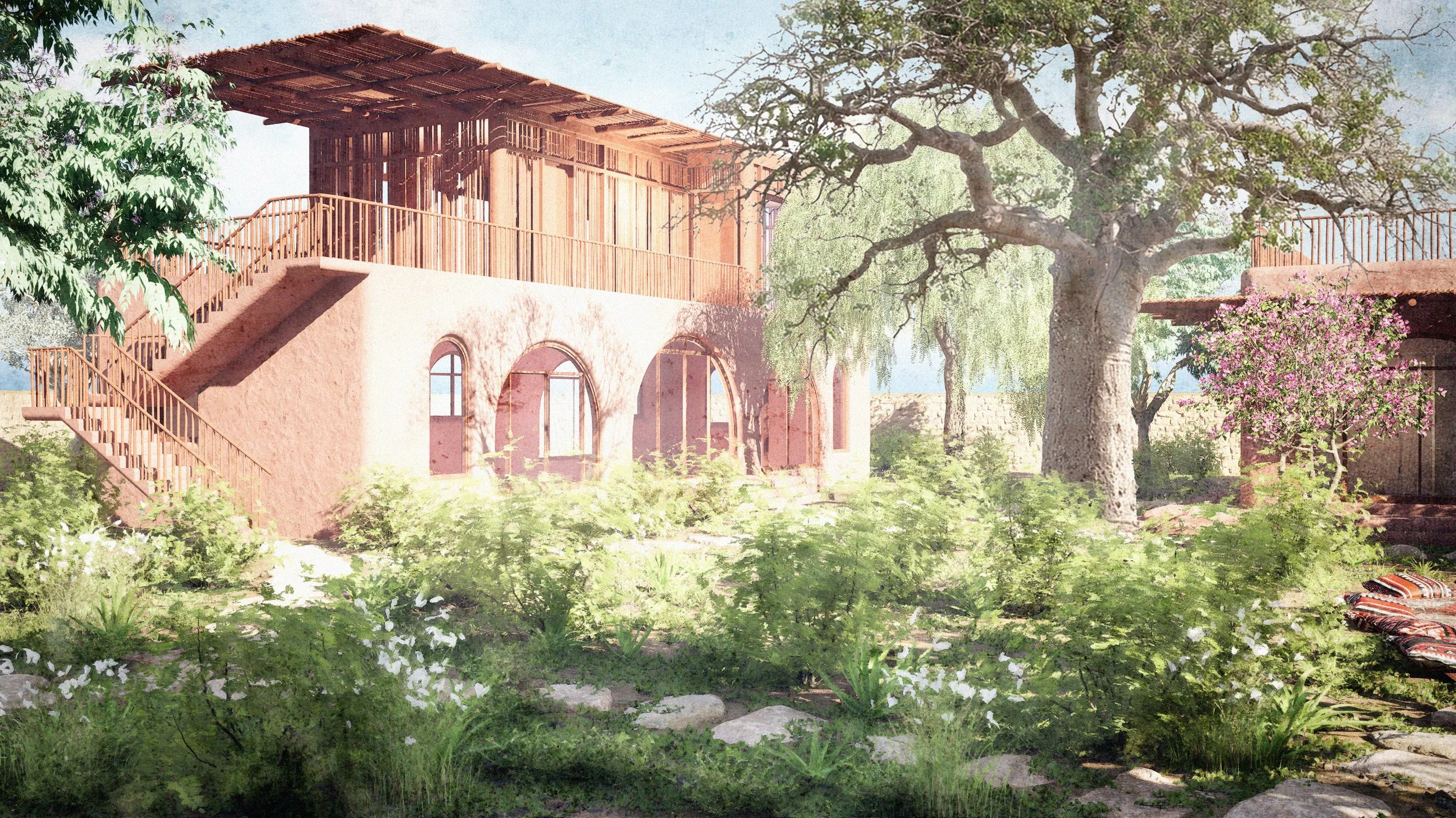 A two-story building with arched windows, surrounded by lush green plants and trees, with a wooden staircase leading to a balcony.