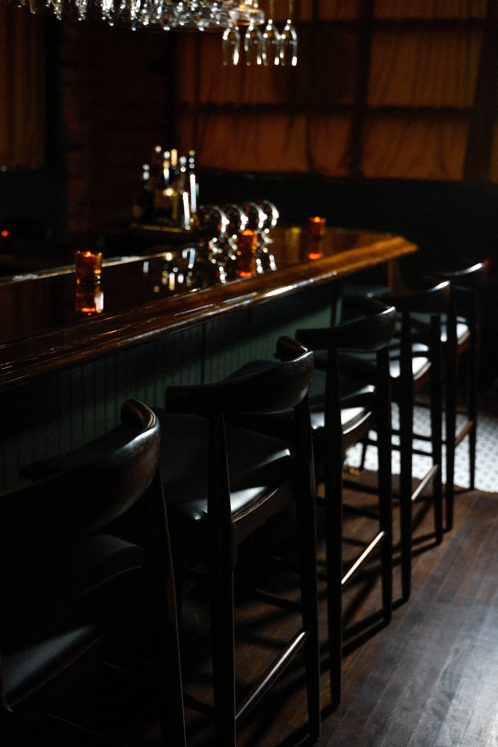 A dimly lit bar with empty seats